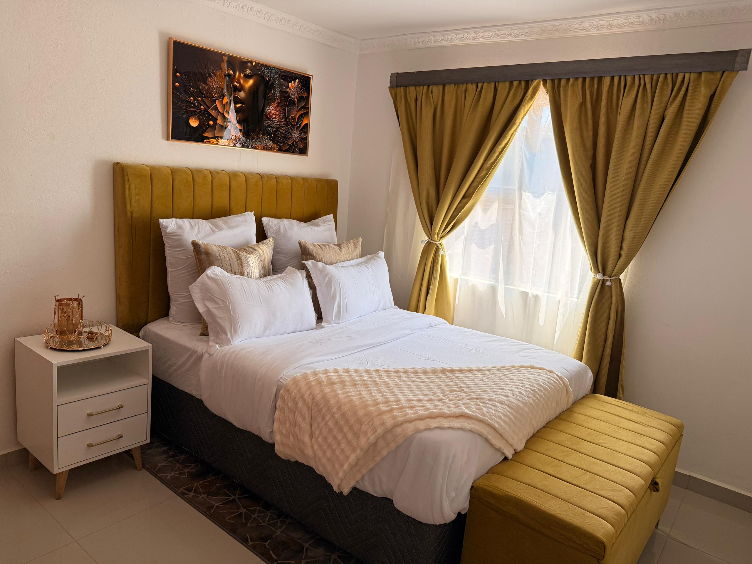 Bedroom with gold upholstered headboard